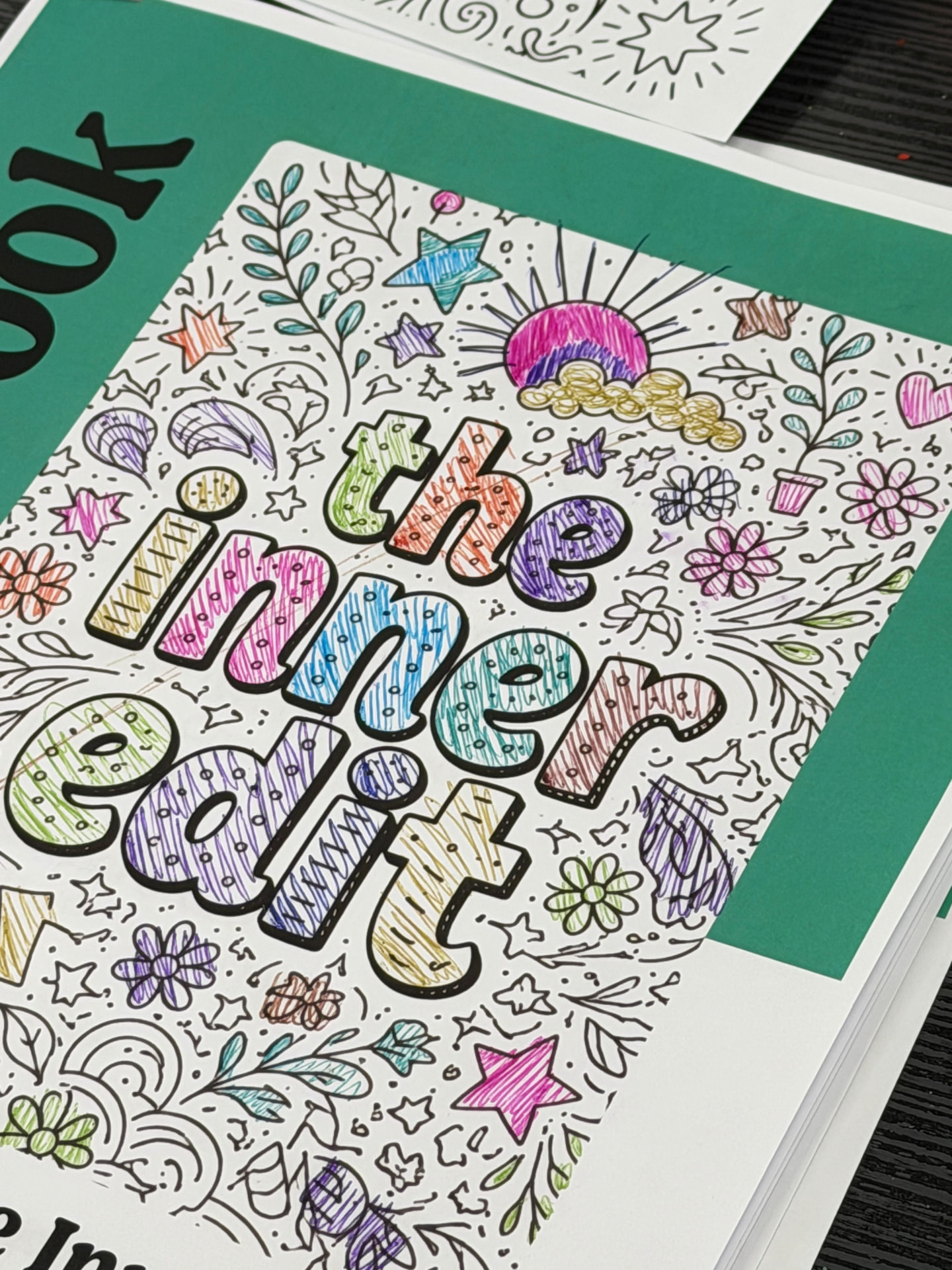 The Inner Edit workbook cover, hand coloured with doodles and bright lettering